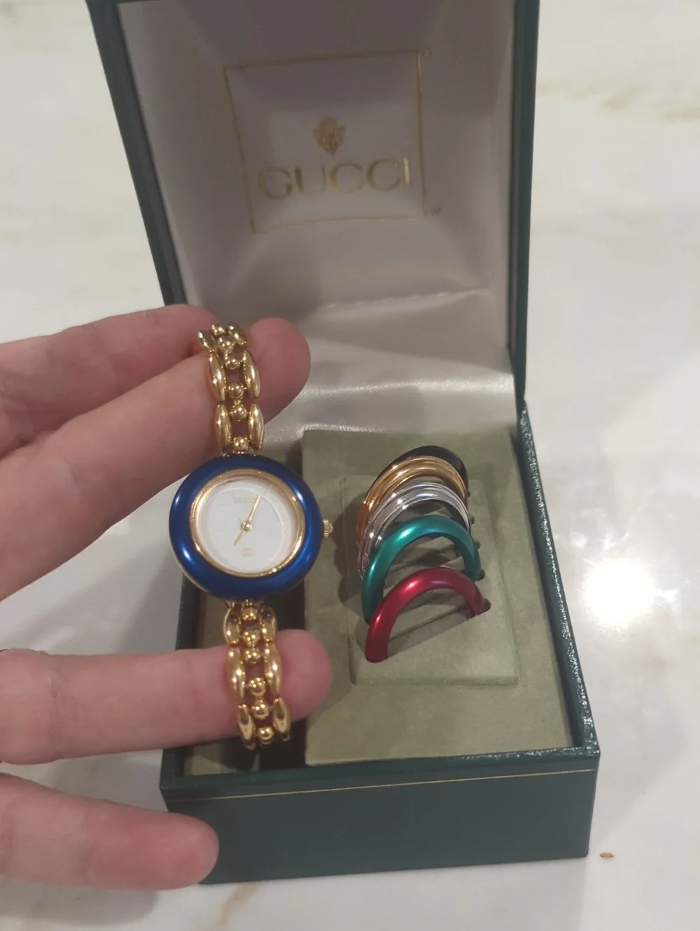 Gucci Gold Bracelet Watch with Blue Bezel and Multi-Color Interchangeable Bezels